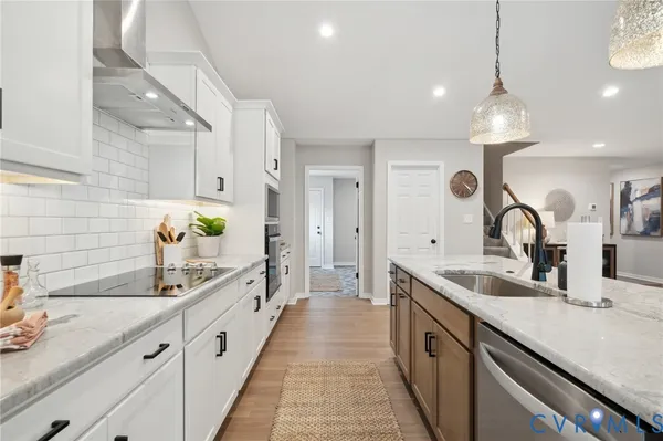 a open kitchen with stainless steel appliances granite countertop a stove and kitchen island