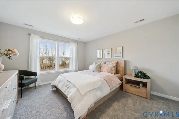 a bedroom with a bed and a mirror