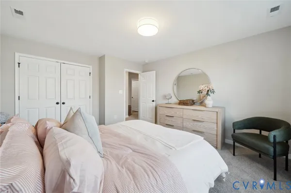 a bedroom with bed and a painting on the wall