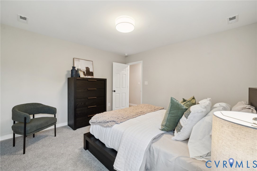 Tbd North Shore Road Locust Hill, VA 23092 - Photo 33 of 40 a bedroom with a bed and a lamp on dresser