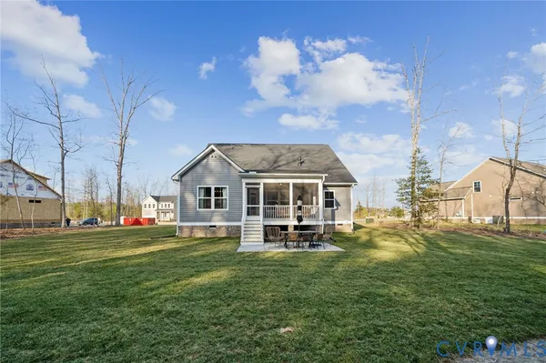 a view of a house with backyard porch and sitting area