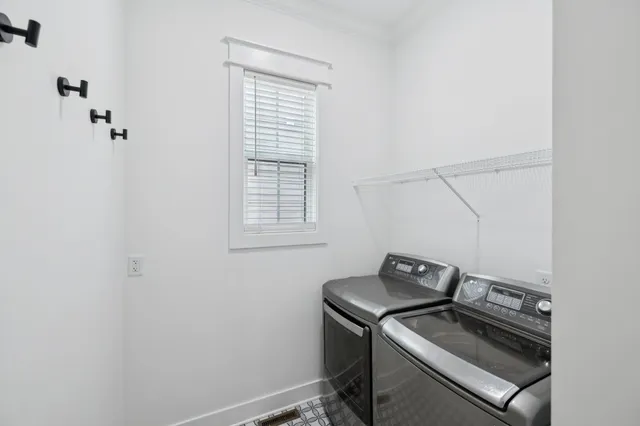 a view of walk in closet with wooden floor and windows