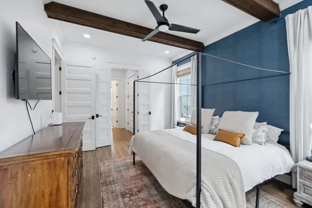 a bed room with a bed window and a flat screen tv