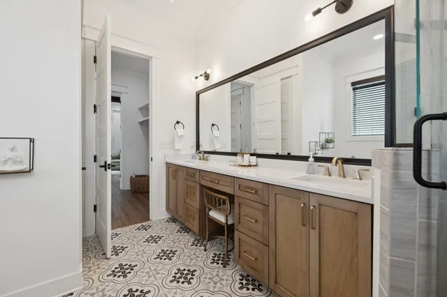a en suite bathroom with a granite countertop sink and a mirror