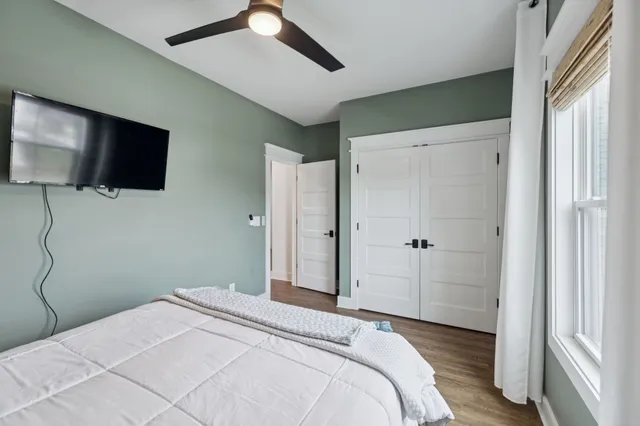 a dining room with furniture and a floor to ceiling window