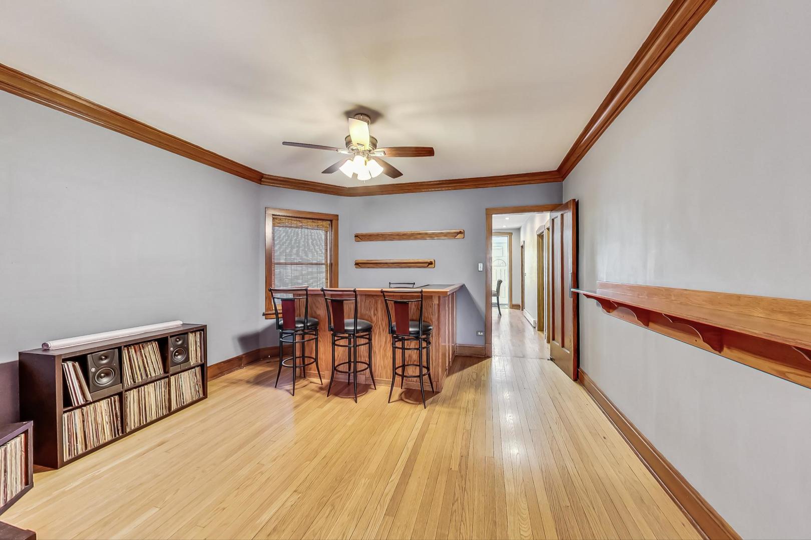3929 North Drake Avenue Chicago, IL 60618 - Photo 12 of 60 a view of a dining room with furniture and wooden floor