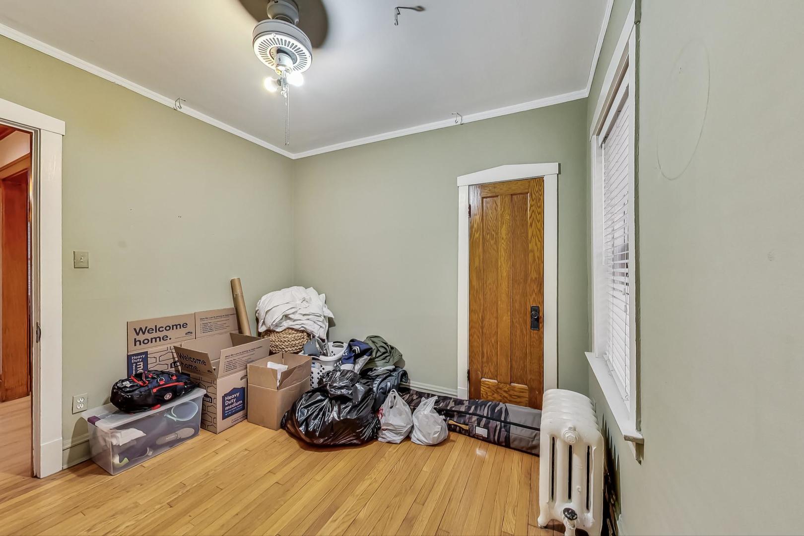 3929 North Drake Avenue Chicago, IL 60618 - Photo 20 of 60 a bed room with a bed and a window
