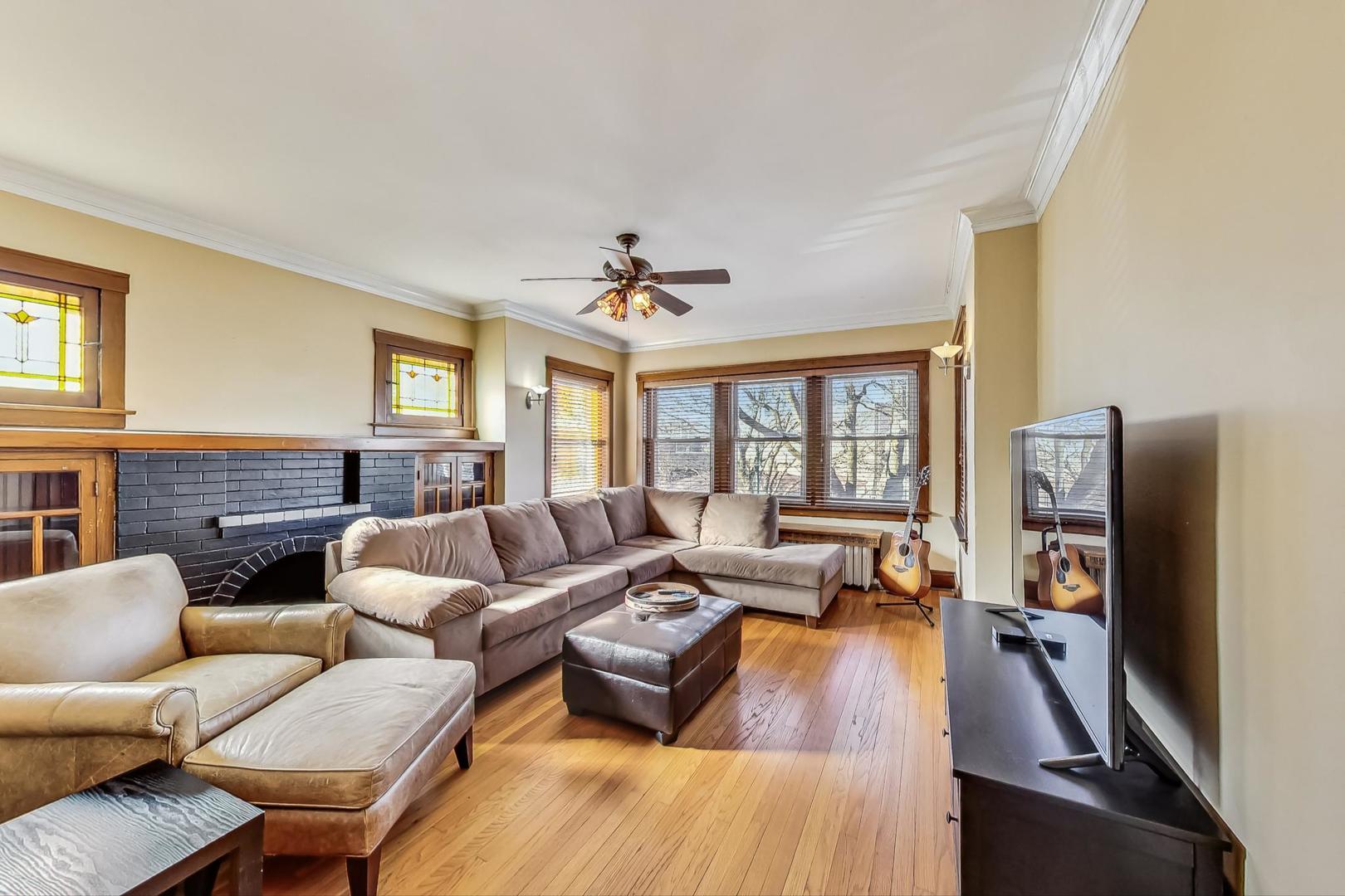 3929 North Drake Avenue Chicago, IL 60618 - Photo 28 of 60 a living room with furniture and a flat screen tv