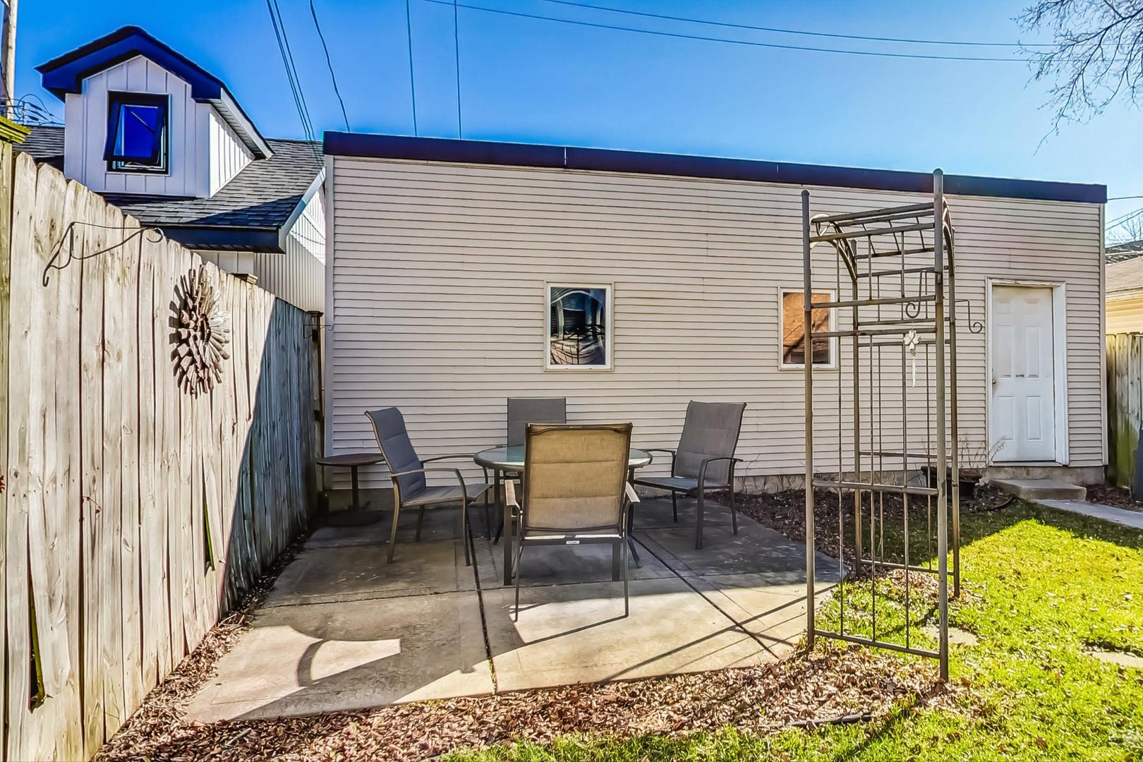 3929 North Drake Avenue Chicago, IL 60618 - Photo 54 of 60 a backyard of a house with table and chairs