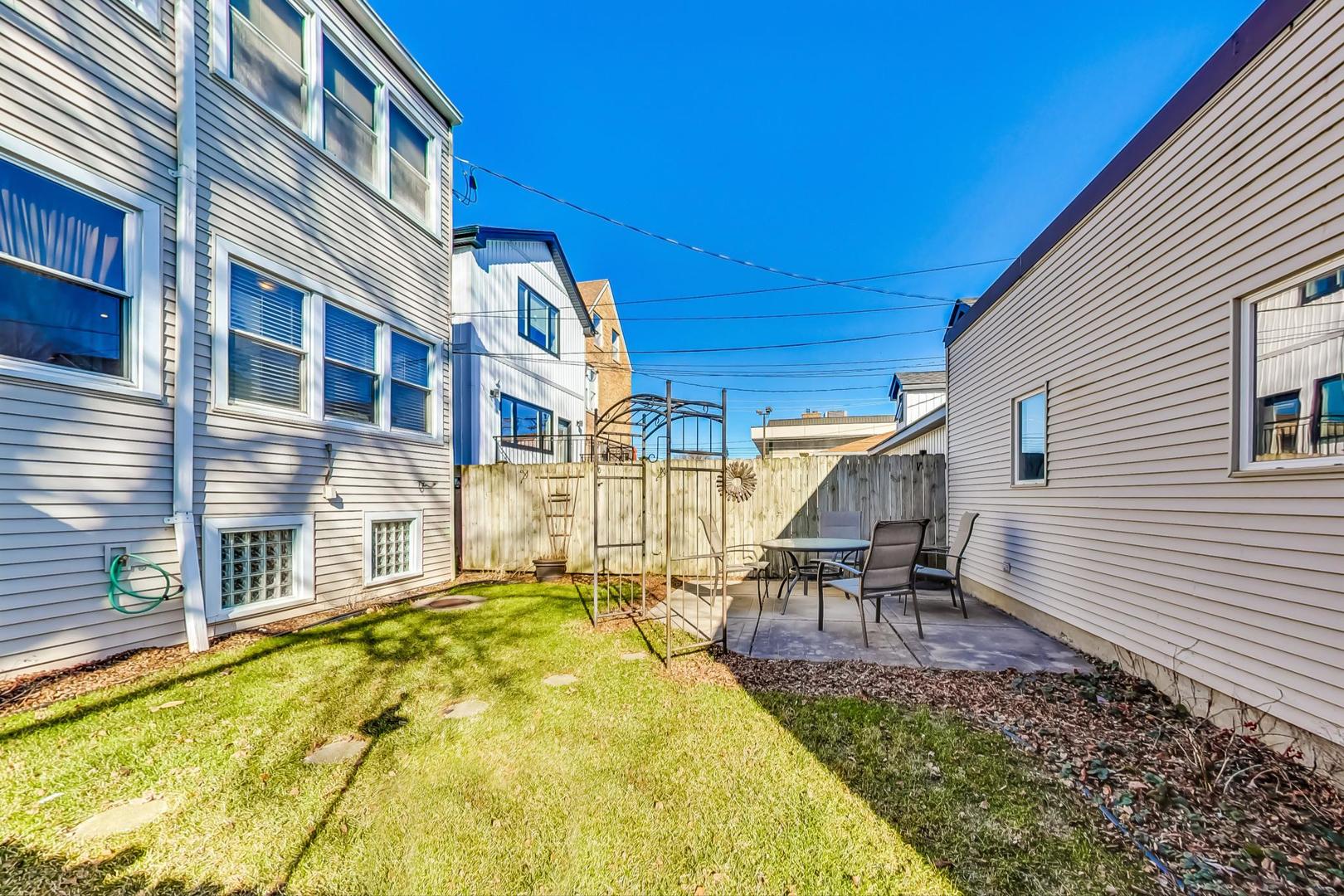 3929 North Drake Avenue Chicago, IL 60618 - Photo 57 of 60 a swimming pool with outdoor seating and yard
