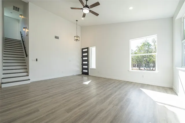 a view of a kitchen with a sink wooden floor and windows