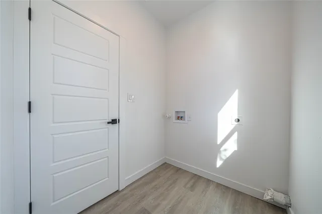 a very nice looking kitchen with granite countertop a stove a sink a window and white cabinets