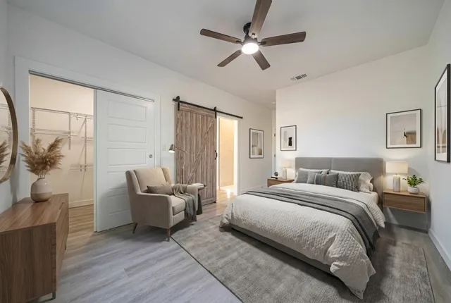 a bedroom with a bed couch and a window