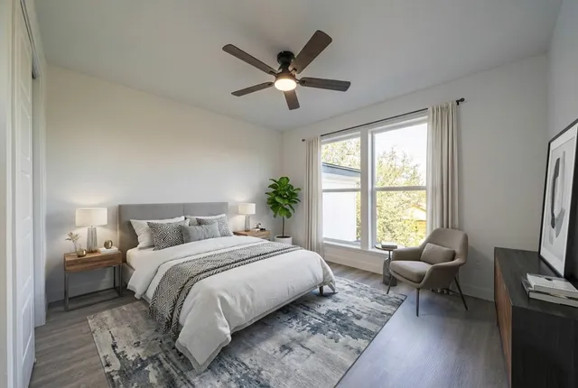 a bedroom with a bed couch and a window