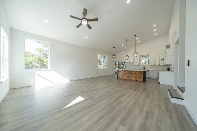 a living room with furniture and kitchen view