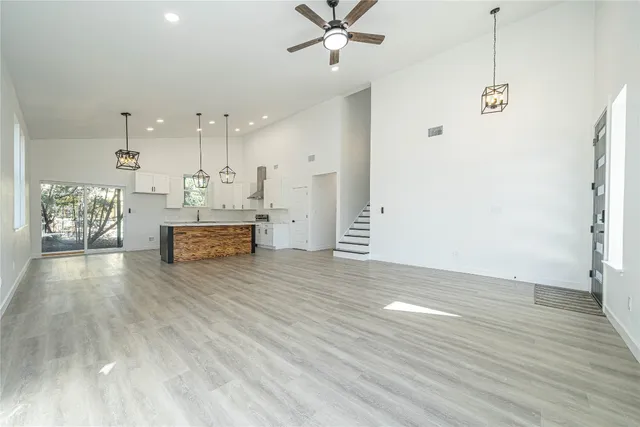 a view of kitchen and hall with wooden floor
