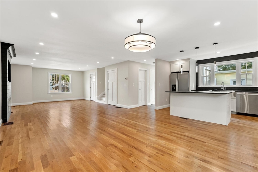 17 Emerson Street Stoneham, MA 02180 - Photo 20 of 41 an open space with kitchen view and wooden floor