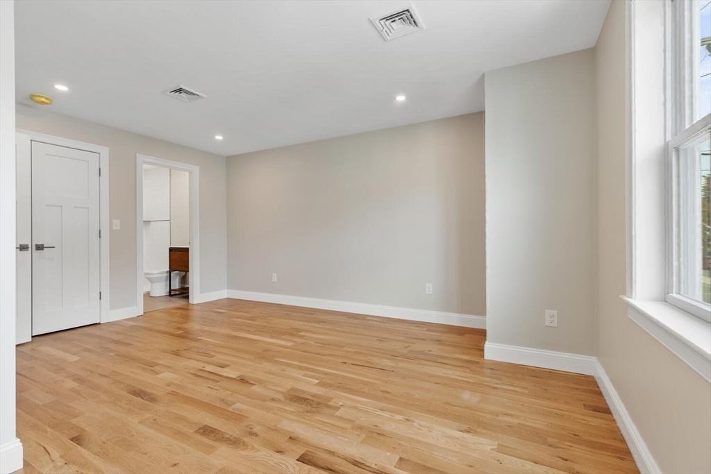 17 Emerson Street Stoneham, MA 02180 - Photo 28 of 41 a view of an empty room with wooden floor and a window