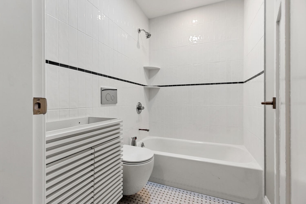 17 Emerson Street Stoneham, MA 02180 - Photo 29 of 41 a bathroom with a bathtub and a shower