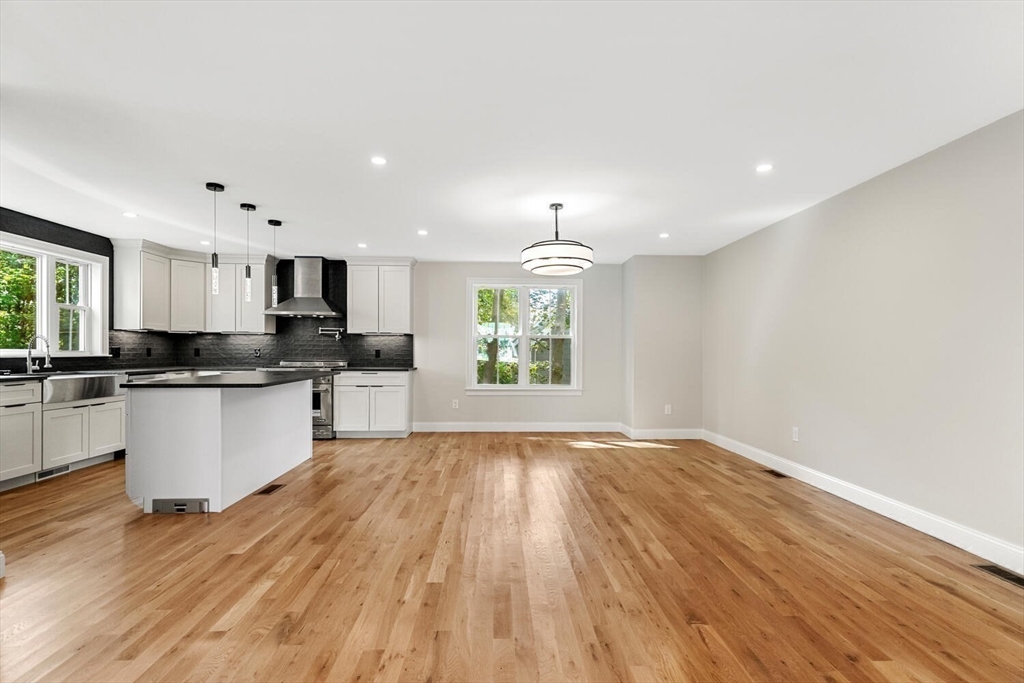 17 Emerson Street Stoneham, MA 02180 - Photo 31 of 41 a large kitchen with hardwood floor sink stainless steel appliances and cabinets
