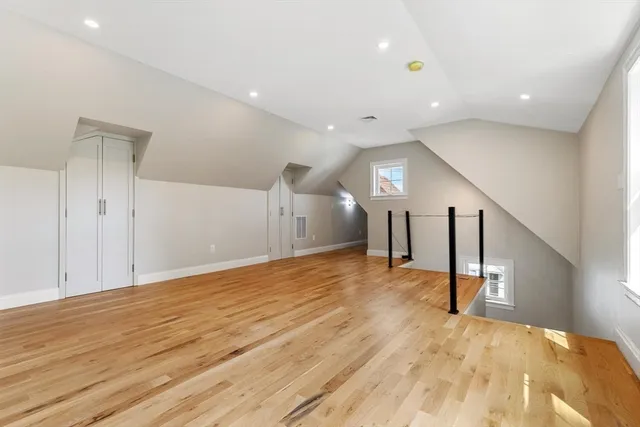 a view of empty room with wooden floor