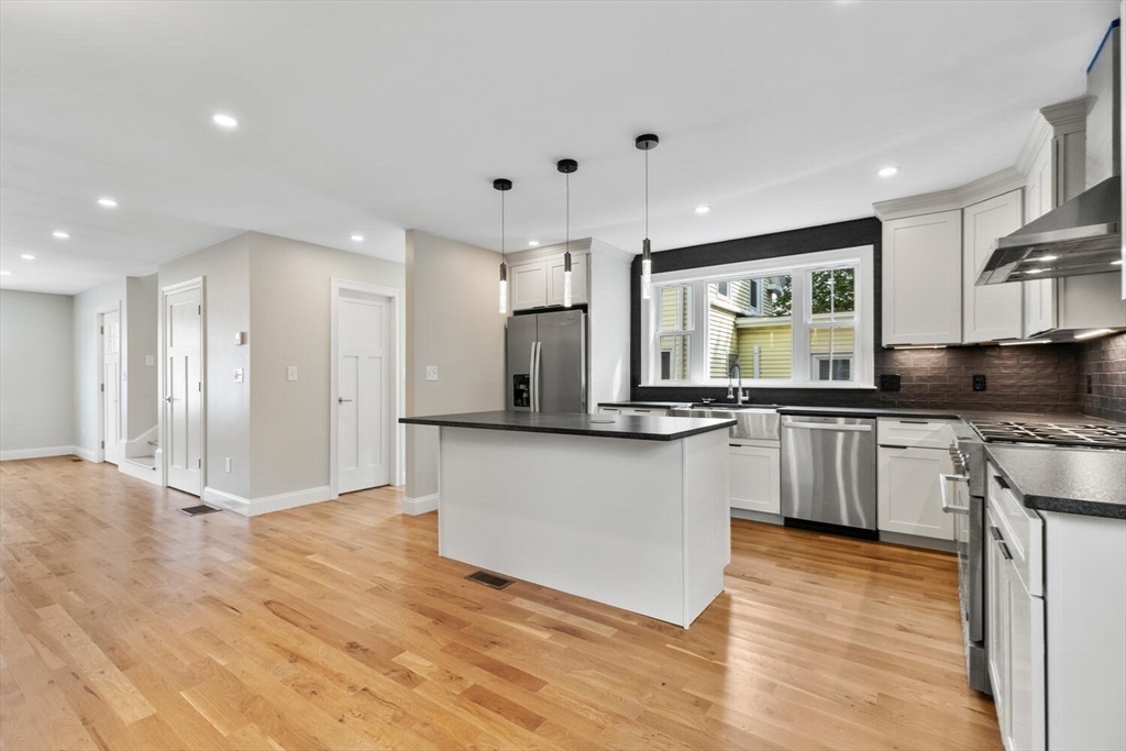 17 Emerson Street Stoneham, MA 02180 - Photo 10 of 41 a kitchen with stainless steel appliances granite countertop a refrigerator a sink and a stove