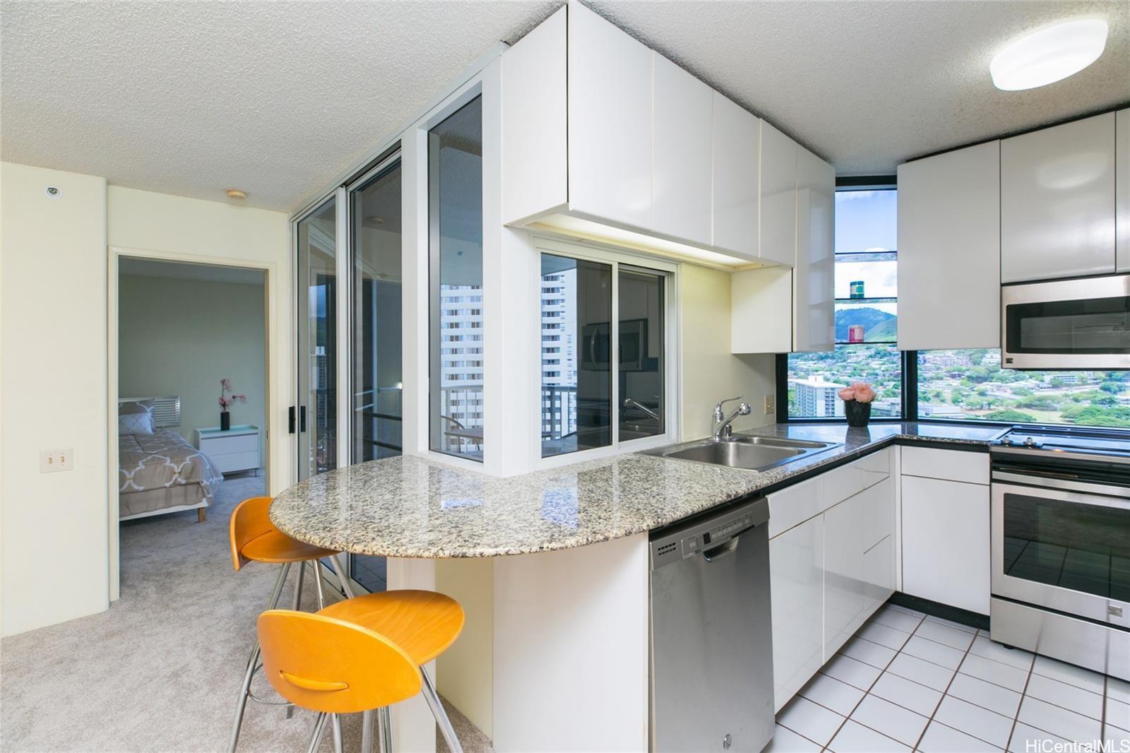 a kitchen with stainless steel appliances granite countertop a sink and a counter top space