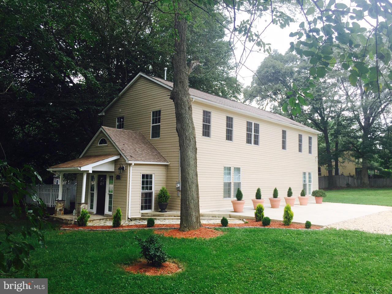 8201 Allentown Road Fort Washington, MD 20744 - Photo 1 of 24 a front view of a house with a yard and trees