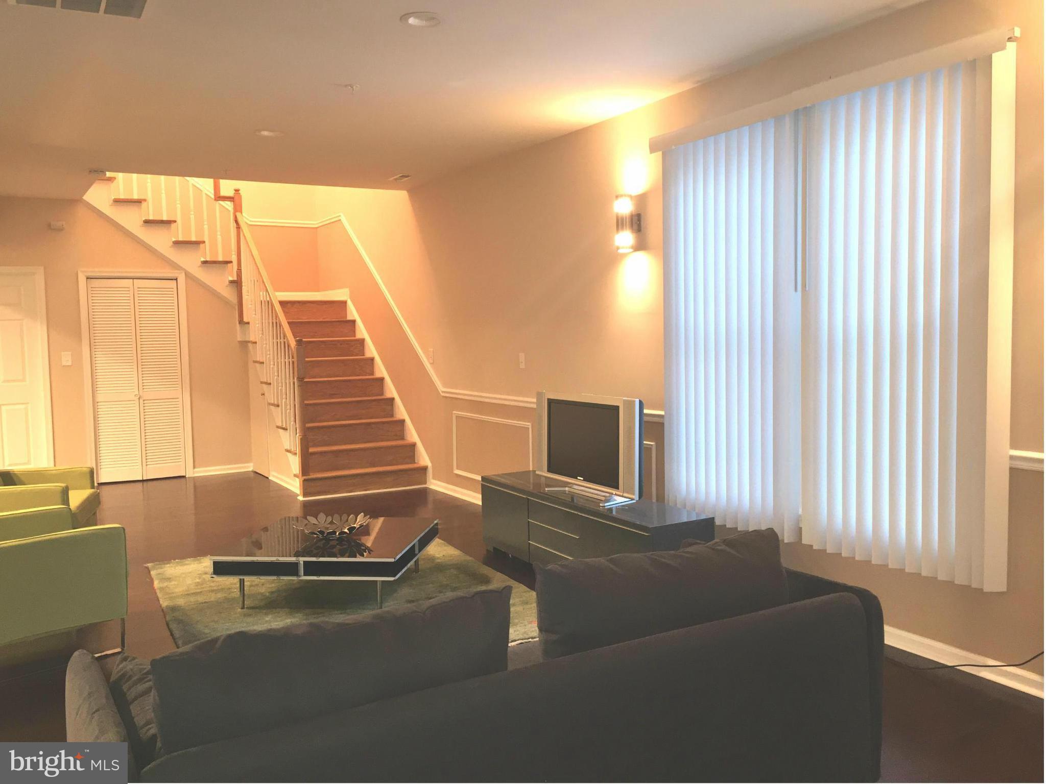 8201 Allentown Road Fort Washington, MD 20744 - Photo 6 of 24 a living room with furniture and a flat screen tv