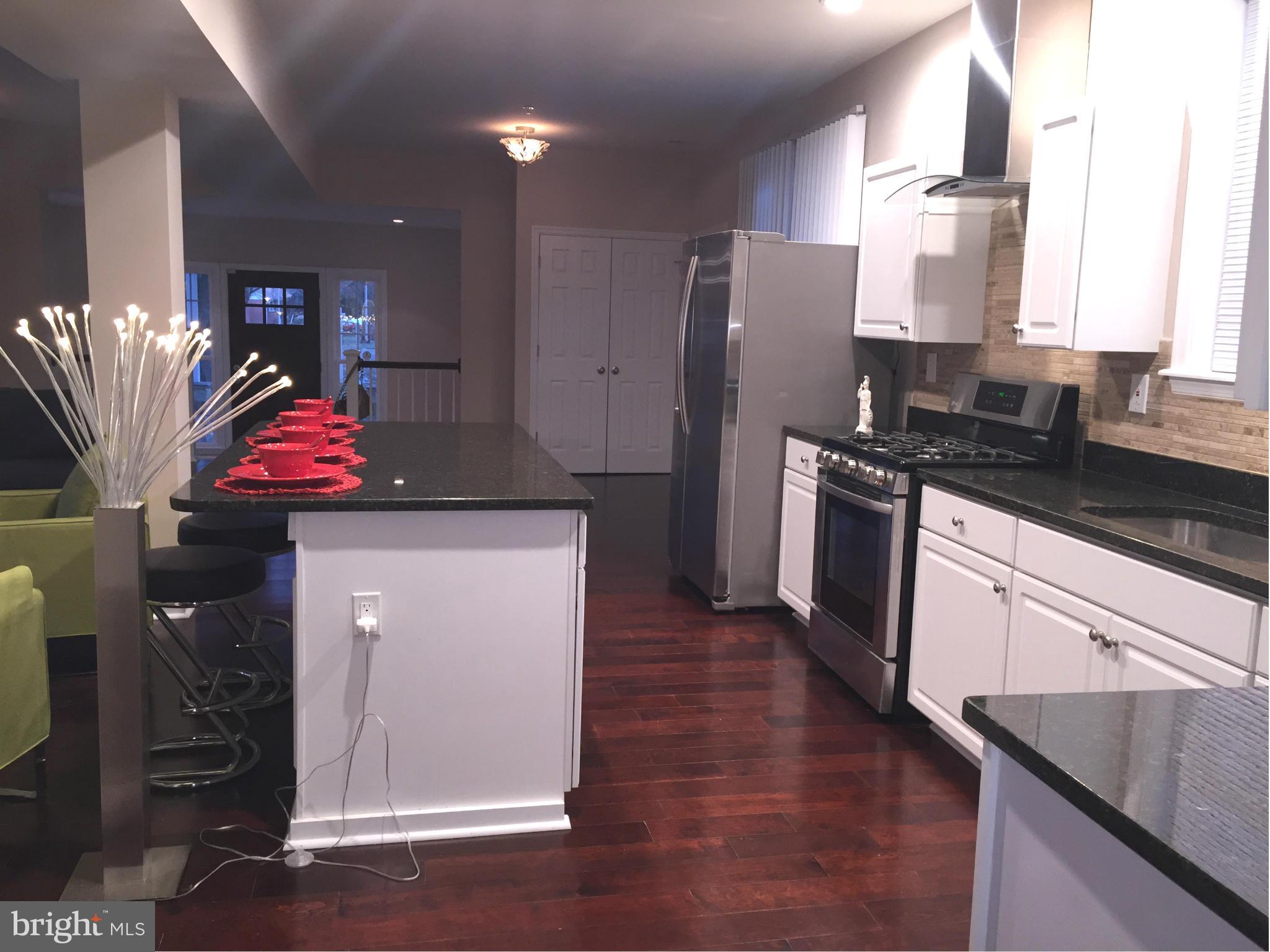 8201 Allentown Road Fort Washington, MD 20744 - Photo 9 of 24 a kitchen with stainless steel appliances granite countertop a refrigerator a stove and a sink