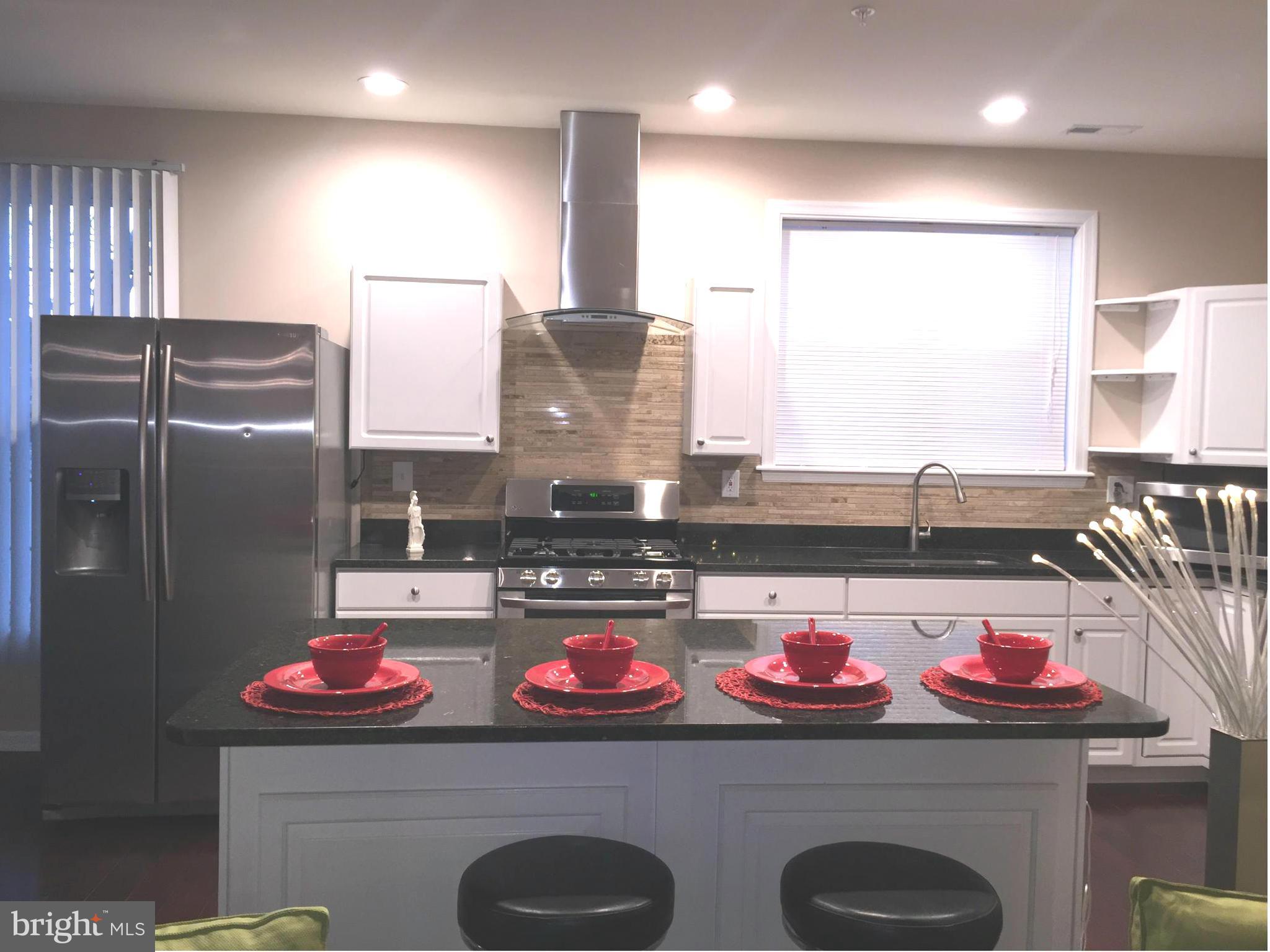 8201 Allentown Road Fort Washington, MD 20744 - Photo 10 of 24 a kitchen with a stove and a refrigerator