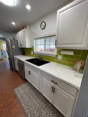 a kitchen with a sink and a stove top oven