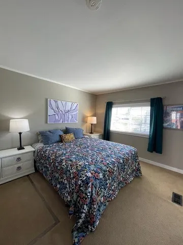 a bedroom with bed and window