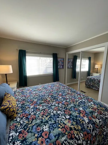 a bedroom with bed and window