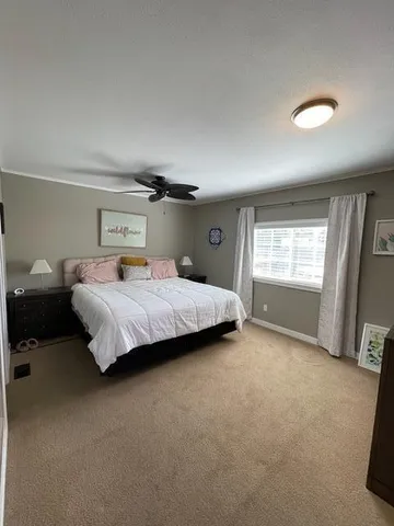 a large bedroom with a large bed and a window