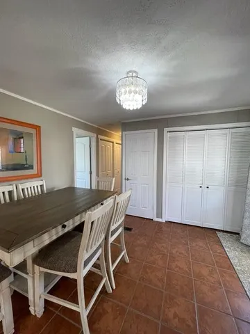 a large white kitchen with lots of counter space a sink and appliances