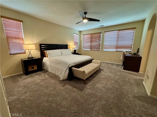 a spacious bedroom with a bed and window