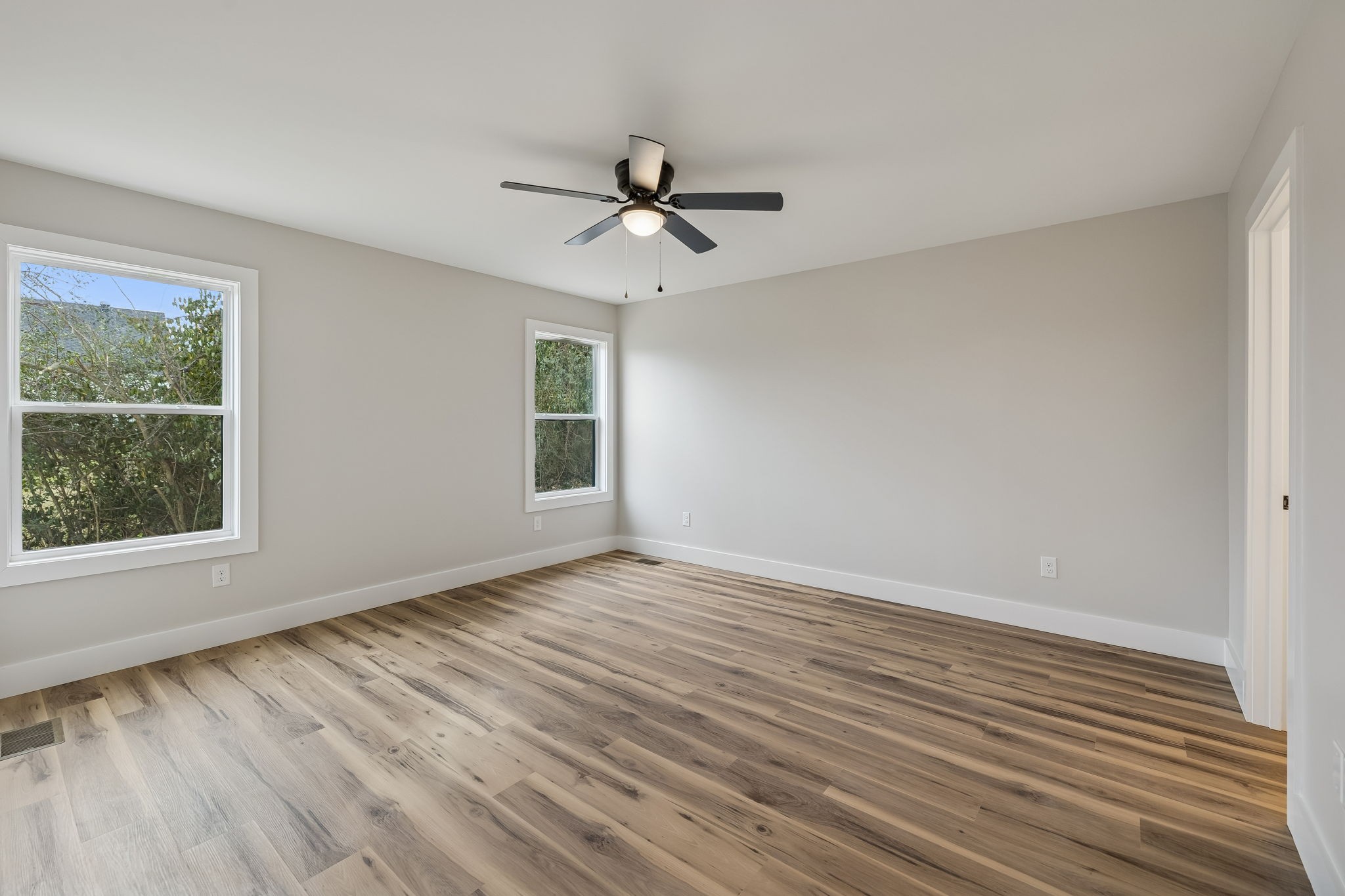 108 Read Avenue Carthage, TN 37030 - Photo 10 of 21 an empty room with wooden floor ceiling fan and windows