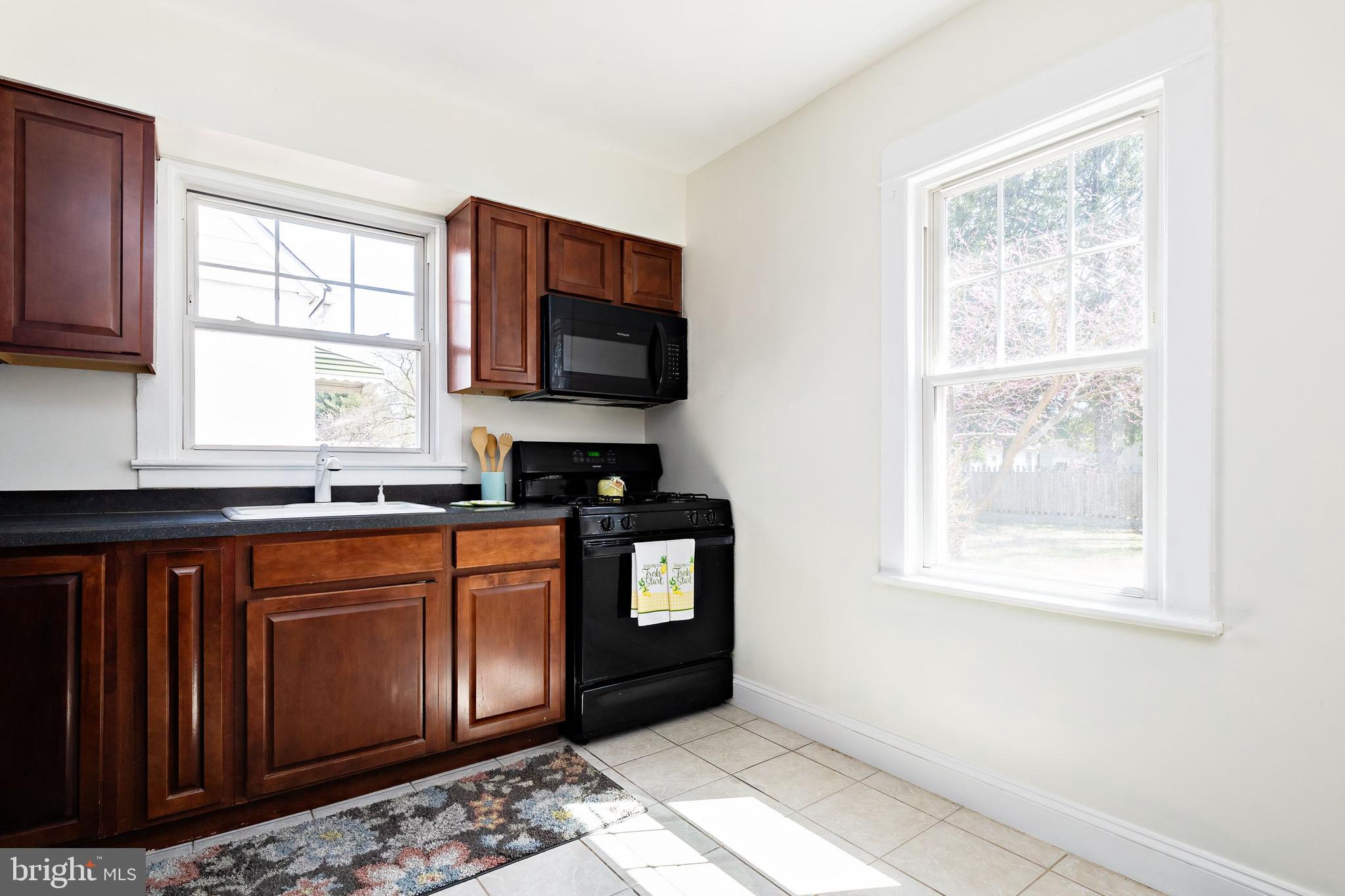 1944 Narberth Avenue Haddon Heights, NJ 08035 - Photo 19 of 61 a kitchen with stainless steel appliances granite countertop a sink stove and microwave