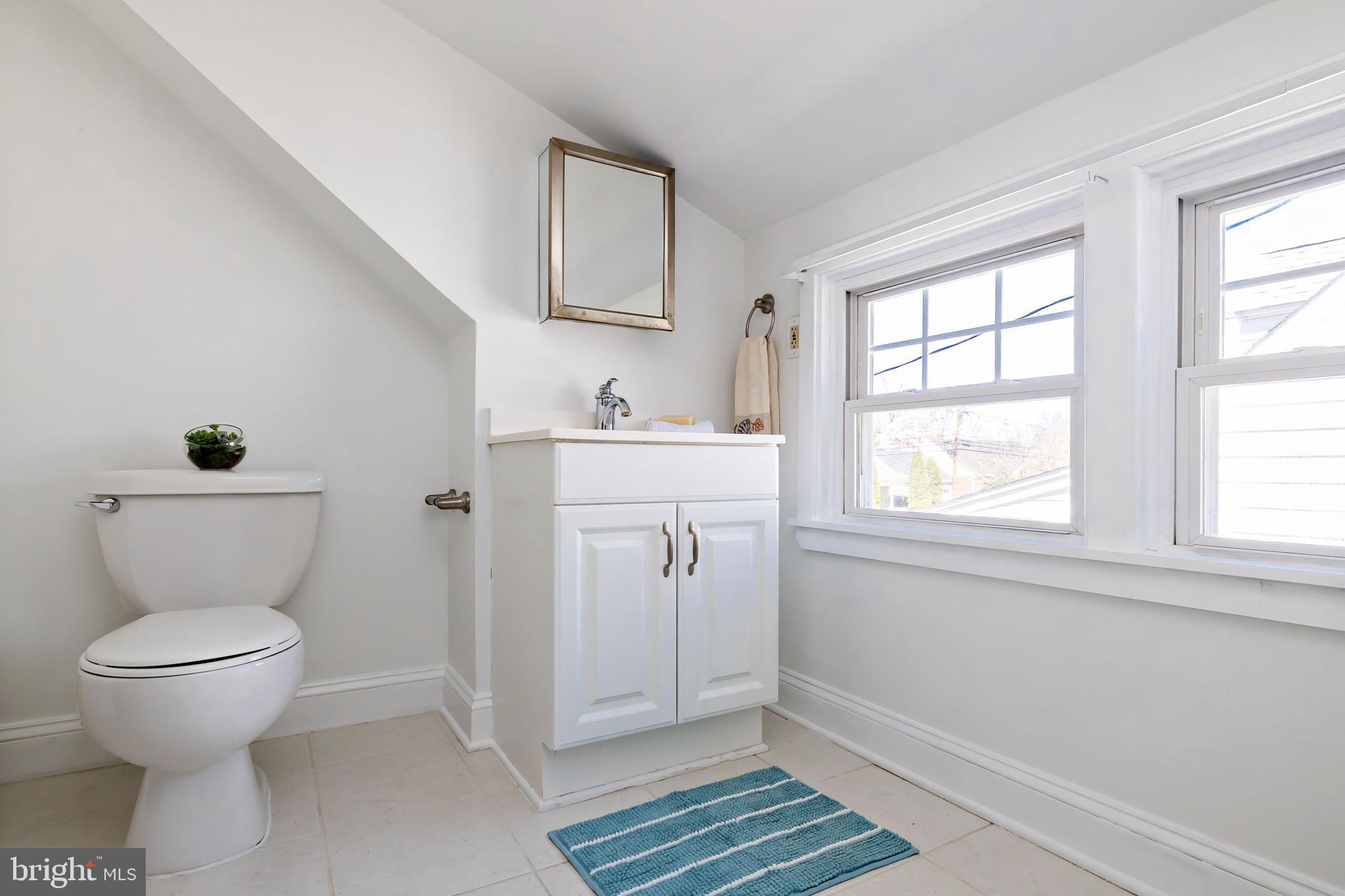1944 Narberth Avenue Haddon Heights, NJ 08035 - Photo 37 of 61 a bathroom with a toilet a sink and mirror