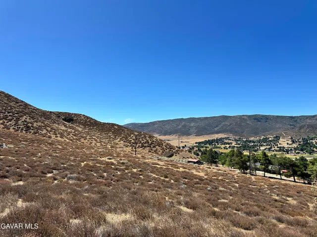a view of a mountain range in a cloudy sky