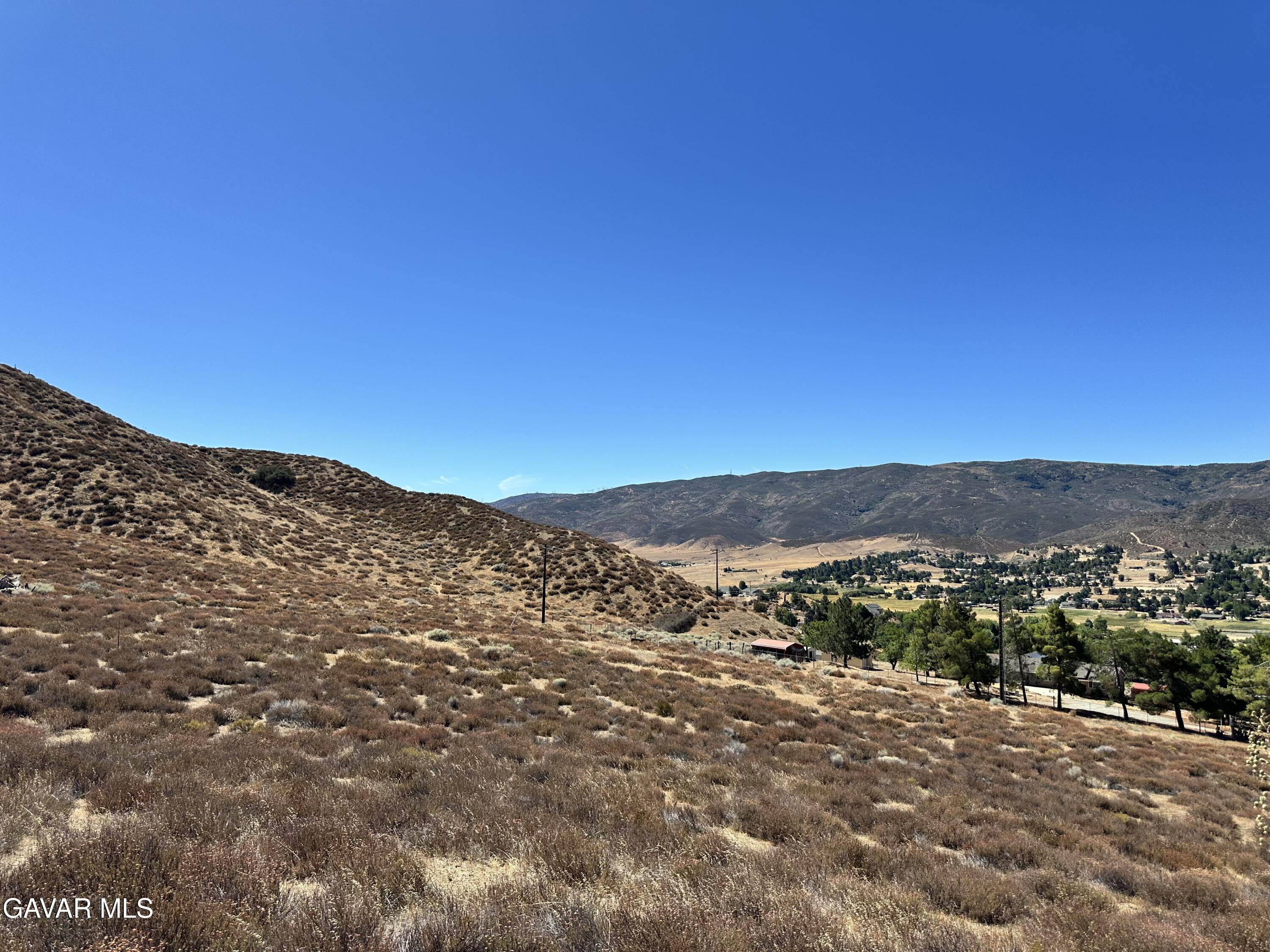 90th Street West Palmdale, CA 93551 - Photo 6 of 10 a view of a mountain range in a cloudy sky