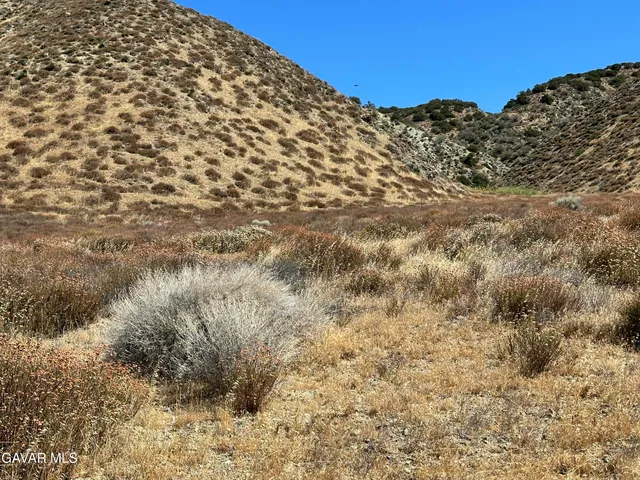 a view of a large building with mountains in the background
