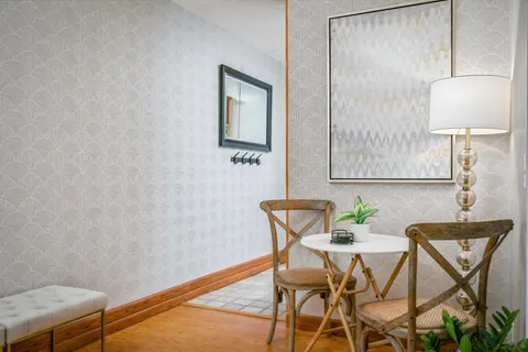 a view of a room with a table and chairs