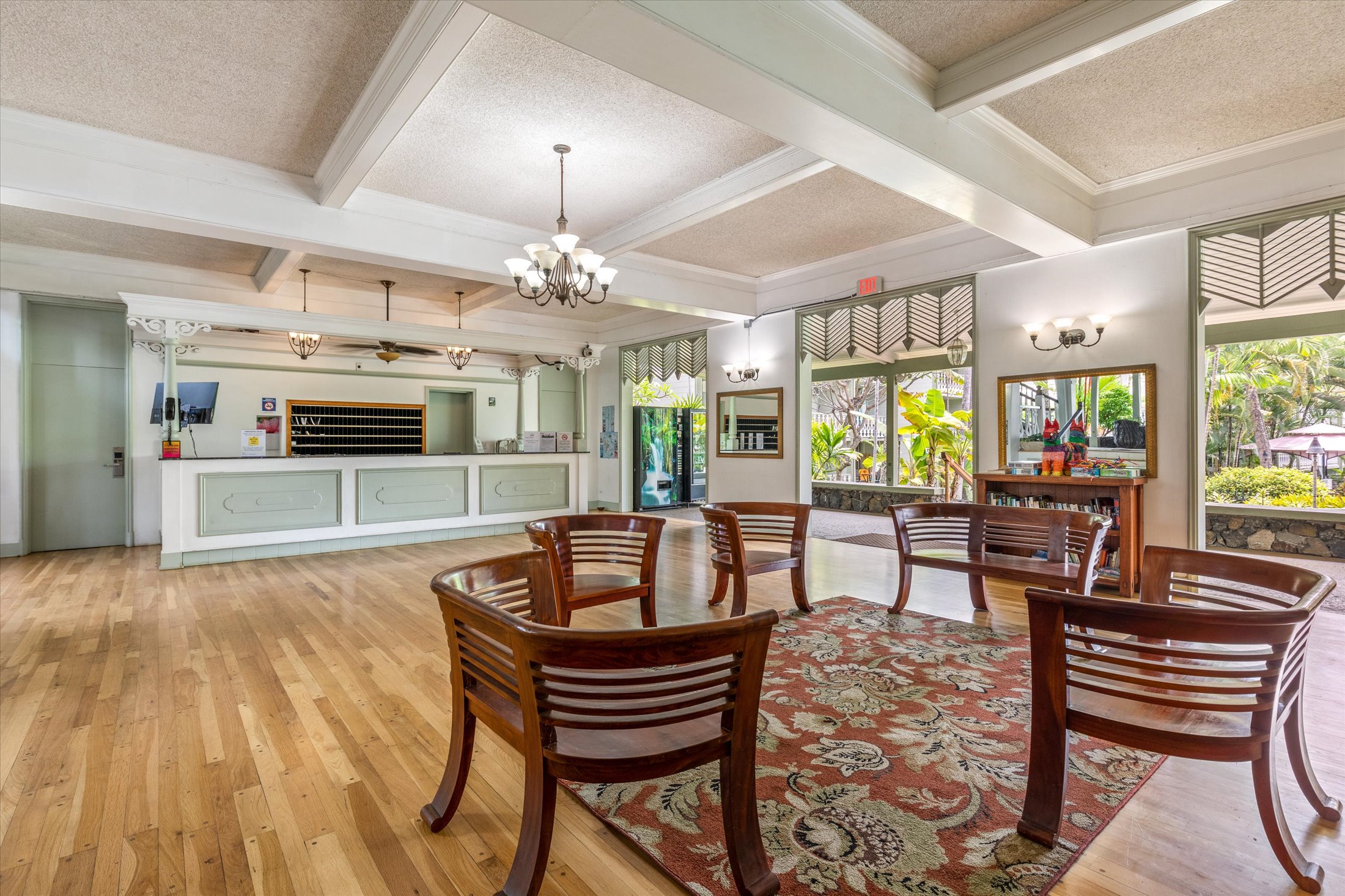 75-5776 Kuakini Highway, Unit 123 Kailua-Kona, HI 96740 - Photo 23 of 26 a dining room with wooden floor and large windows