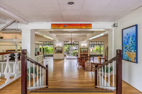 a car parked in front of a building with cars parked