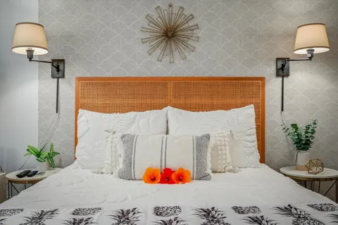 a bedroom with a bed and a potted plant