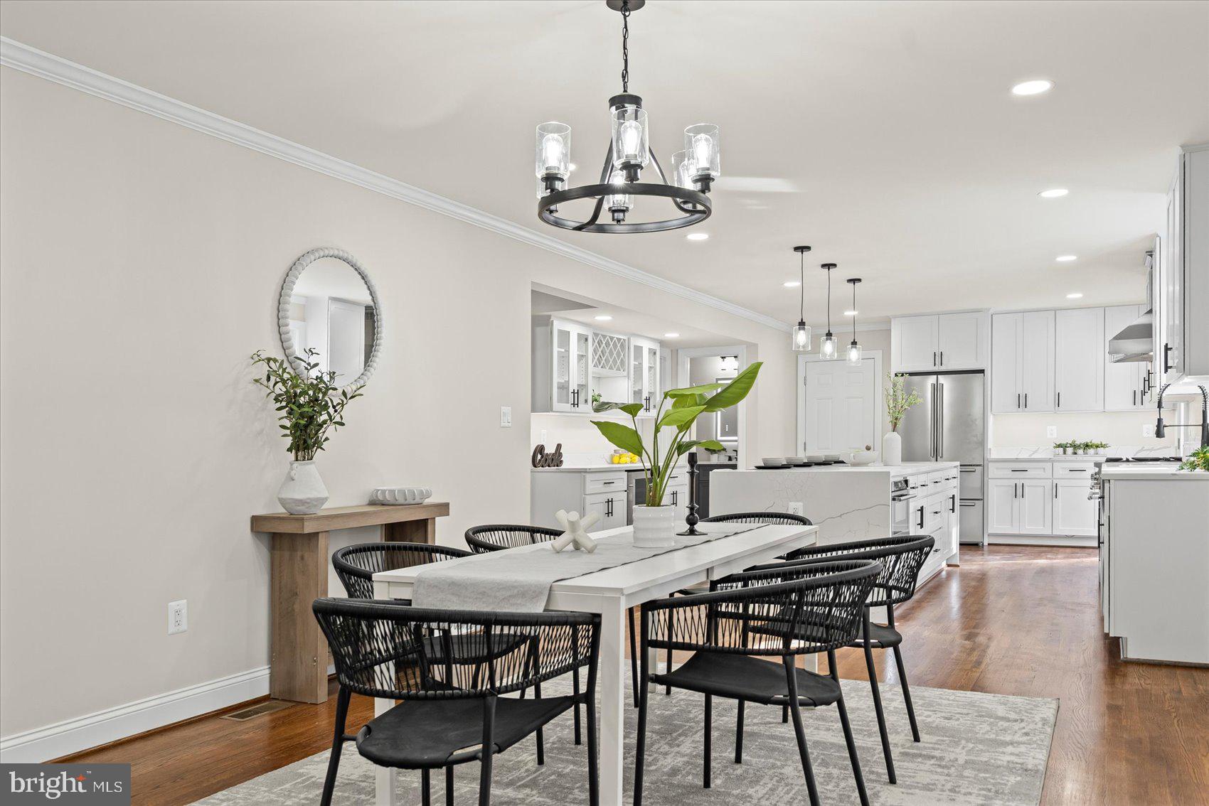 7604 Hackamore Drive Potomac, MD 20854 - Photo 16 of 81 a view of a dining room with furniture and chandelier