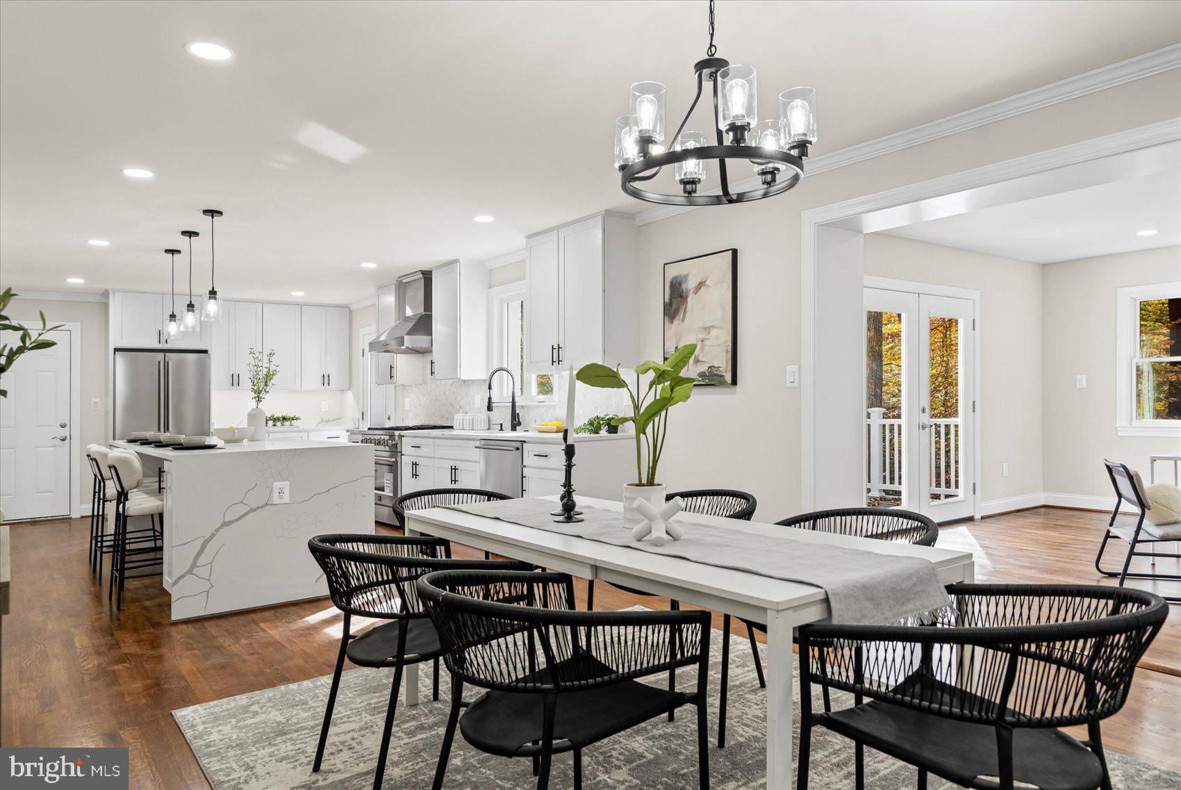 7604 Hackamore Drive Potomac, MD 20854 - Photo 17 of 81 a view of a dining room with furniture a chandelier and wooden floor