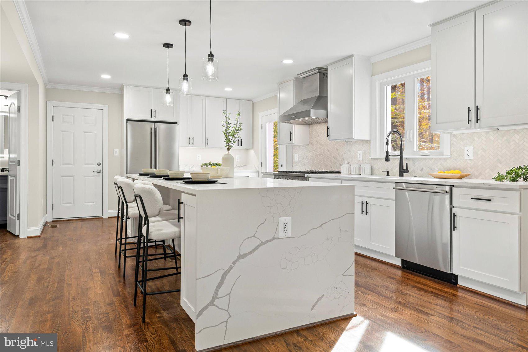 7604 Hackamore Drive Potomac, MD 20854 - Photo 18 of 81 a kitchen with stainless steel appliances kitchen island granite countertop a sink a stove a refrigerator and island with wooden floor